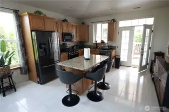 Kitchen with eating space and french doors to large deck.