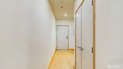 Looking at the front door. Bathroom to the right