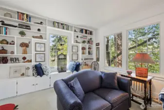 Beautifully encased windows capture the lush green outdoors.