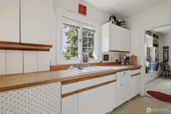A pretty window sits above the sink overlooking the yard.