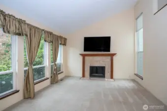 Living area with vaulted ceilings and a welcoming fireplace.