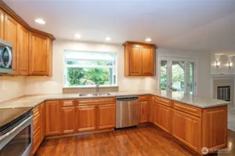 Kitchen boasts stunning granite countertops and a charming bay window above the sink overlooking the backyard.