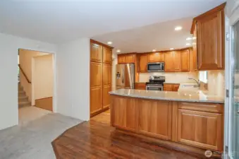 From the family room, you can see the expansive kitchen with an eating bar, and the dining area is just around the corner.
