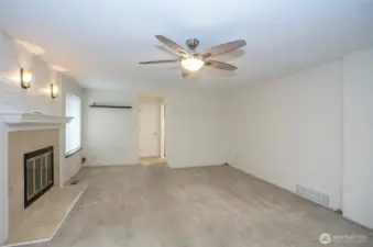 From the kitchen, you can see into the family room, with the powder bath and utility room conveniently located at the far end.