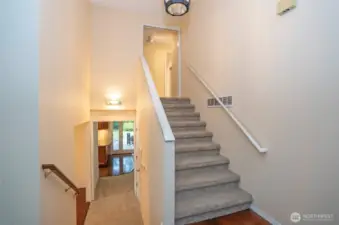 Main entry showcasing stylish staircases that lead to both the upper and lower levels.
