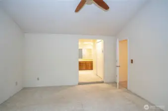 Another perspective of the primary suite, offering a view into the private bathroom.