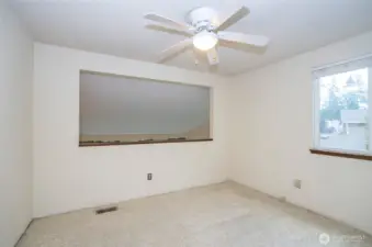Loft area overlooking the main floor living space, offering the flexibility to serve as a 4th bedroom.