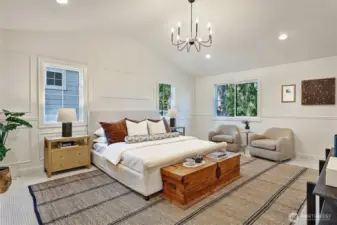 Top floor primary bedroom suite includes soaring vaulted ceilings.