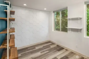 Second floor bedroom with attached shelving. Could serve as an office or bedroom.