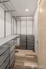 Primary closet with built in organizers.