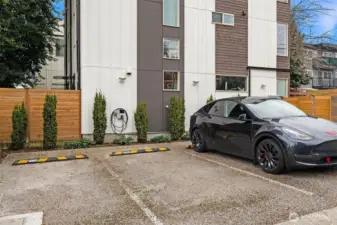 Dedicated parking spot with EV charger located in the alley and a flat walk to the unit.