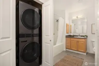 Convenient in-unit stack washer and dryer positioned near the bathroom for everyday ease and efficiency.