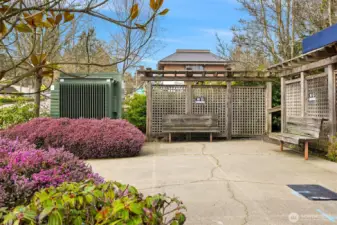 Landscaped outdoor gathering area with seating, providing a quiet space to relax just outside the building.