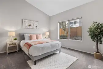 Spacious primary bedroom with vaulted ceilings