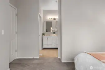 Spacious primary bedroom with vaulted ceilings and en suite