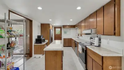 Spacious kitchen with large island, abundant counter space, and plenty of cabinets for all your storage needs.