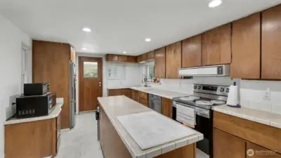 Spacious kitchen with large island, abundant counter space, and plenty of cabinets for all your storage needs.