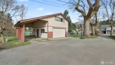 Detached garage features MIL apartment on upper level and covered RV parking.