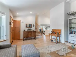 Spacious living room with updated flooring, fresh paint, and abundant natural light creates an inviting gathering space.