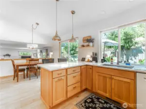 Designer custom lighting highlights the modern kitchen aesthetic.