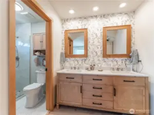 Fully remodeled primary bathroom with double sink vanity and designer finishes.