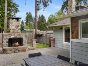 Spend your evenings relaxing by the outdoor fireplace on the spacious patio, surrounded by mature fruit trees within the fully fenced yard.