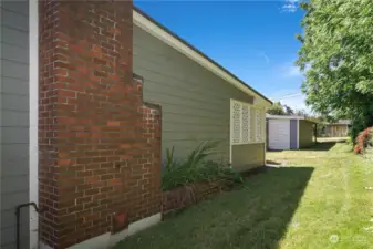 Sideyard of home with a view of the shed door.