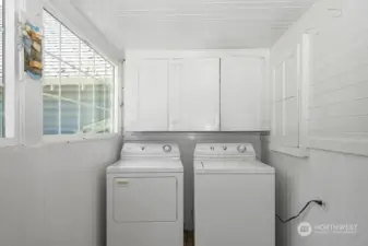 Spacious seperate laundry area & mudroom has entrance to side porch