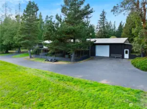 Large shop/barn in 4 sections. on the far right is a party room with pool table, bathroom and sink. The next section is a great shop with hydraulic hoist for working on vehicles & lots of work space. You can see the aviary in the front and on the back side of that is a 4 stall barn, tack room and hay storage. A large greenhouse (approx. 40' x 16') is on the South end of the structure.