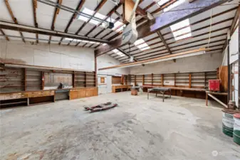 This section of the shop has lots of work space and is set up perfectly to work on vehicles or equipment. Please note the hydraulic hoist and welding table.