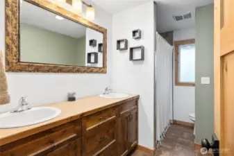 The full bath features tile floors & double sinks!