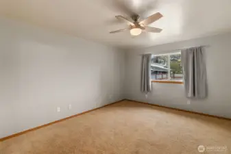 Another view of the primary bedroom. This window faces out to backyard that is fully fenced.