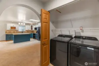 Utility area with washer and dryer behind bifold doors. Notice the coved doorways.