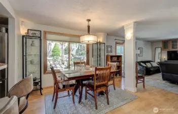 Dining room enjoys a graciously large window and a sliding door out to the backyard oasis