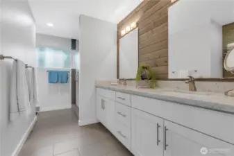 Primary bathroom with heated floors, shower and custom closet