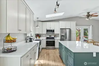 New kitchen with granite slab island, cabinets, & appliances