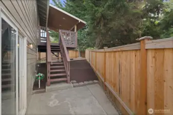 Steps leading up to covered deck in backyard.