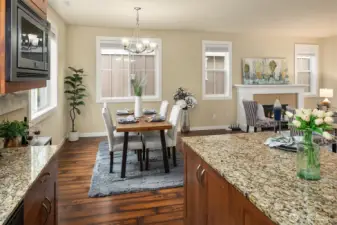 The open concept kitchen flows to the dining area and living room area.