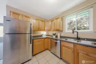 The kitchen has newer stainless steel appliances and look at all of those cabinets.