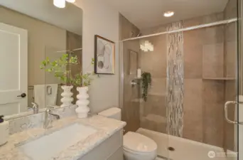 Primary tiled full bath.