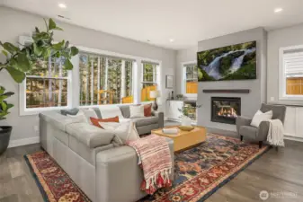 The wall of windows offers abundant light and views of the open, common area beyond your backyard fence