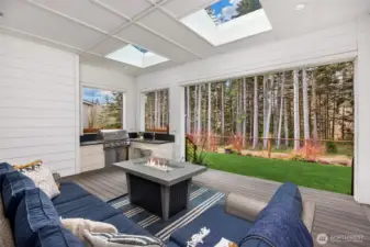 The perfect outdoor space; covered, light, with outdoor grilling and kitchen area. Watch the wildlife in the backyard and in the open, common area beyond the fence