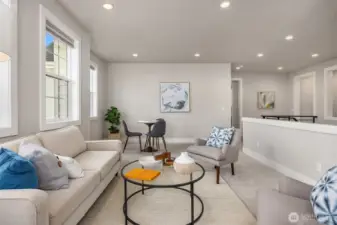 Upstairs you'll find an inviting family room space, bathed in light