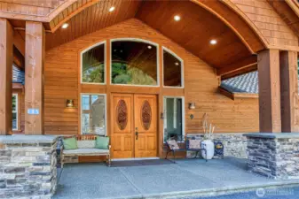 Impressive covered entry & custom carved wood doors