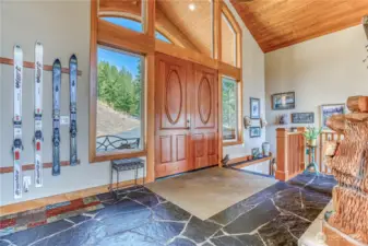 Entry has a beautiful S. African slate floor, fireplace, & cathedral ceilings