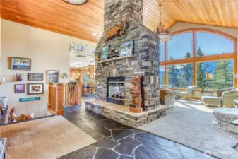 Stairs to the daylight lower level are right off the entry. Double sided propane Fireplace is centrally located for cozy, quiet heat & ambiance. Stone chimney is an impressive centerpiece for the main floor.