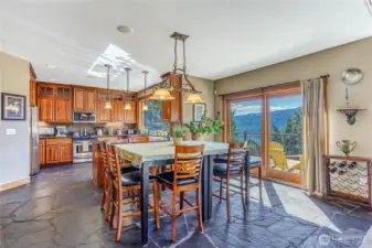 Dining area features S. African Slate flooring & a full sliding door to the wrap around deck. Lake views from every room all year long! Open floor plan flows easily from living area to the kitchen.