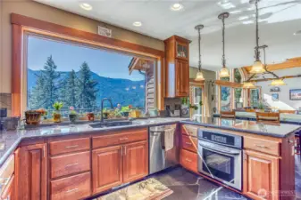 Open floorplan & spectacular views abound. Bar counter with teardrop custom lighting is the only divider from the dining & living areas.