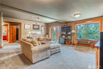 Large downstairs rec room/family room has a slider to the patio, views of the lake, wall-to-wall carpet, & is centrally located.