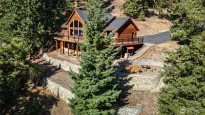 Terraces below the patio are a great spot for raised garden beds. Firepit area to enjoy year around.